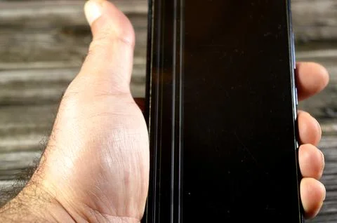 A smartphone with a damaged display, with a vertical lines on the screen, t.. 스톡 사진