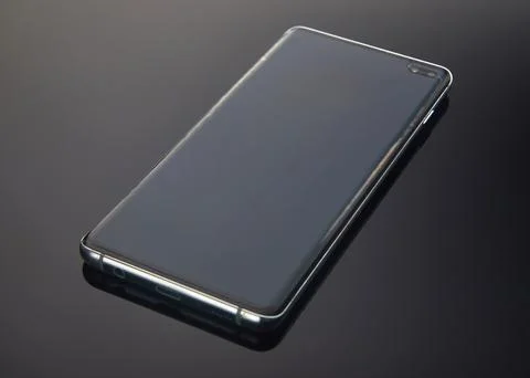 Smartphone on a dark gradient background with reflection. Place for text Stock Photos