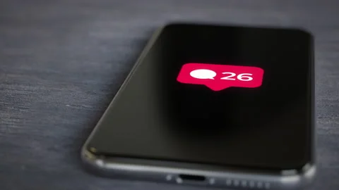 Smartphone on a desk showing comment countter popup notification 4k Stock Footage 158540895