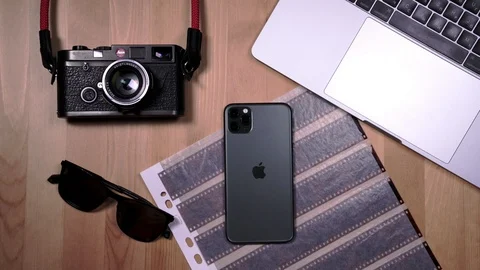 Smartphone on a desktop background with a book and a film camera Stock Footage 124282211