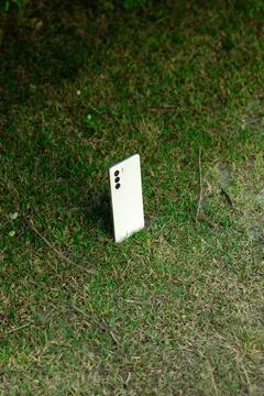 Smartphone Device Standing Upright in Grass Stock Photos
