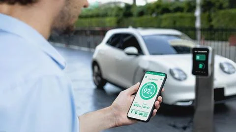 Smartphone display battery status interface by smart EV app. Peruse Stock Photos