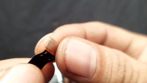 Smartphone Display Flexible Cable Held by Hand in Macro Shot Stock Footage 310142928