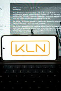 Smartphone displaying kln logo on computing keyboard Stock Photos
