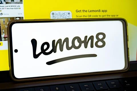 Smartphone displaying lemon8 app logo on laptop keyboard Stock Photos
