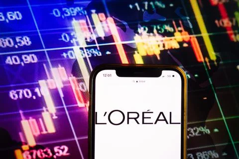 Smartphone displaying logo of LOreal SA company Stock Photos
