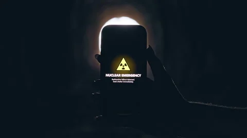 Smartphone Displaying Nuclear Emergency Warning in Dark Underground Tunnel, Cine Stock Footage 335203288