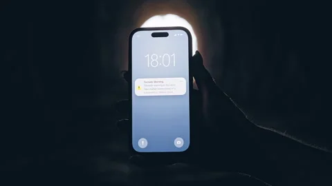 Smartphone Displaying Tornado Warning Notification Inside Dark Tunnel With Brigh Stock Footage 335203673