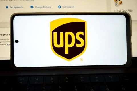 Smartphone displaying ups logo on keyboard Stock Photos