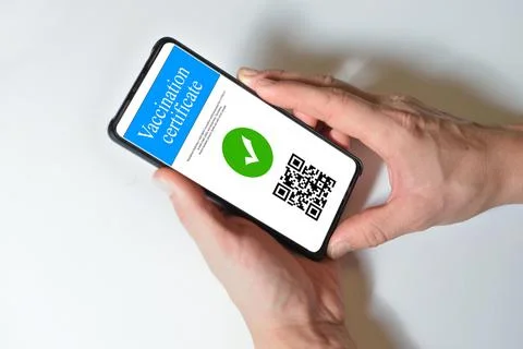 Smartphone displaying a valid digital vaccination certificate passport for COVID Stock Photos