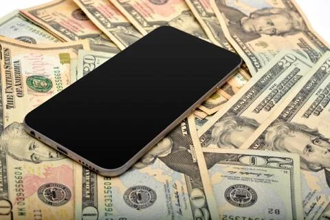Smartphone with dollars in background Stock Photos