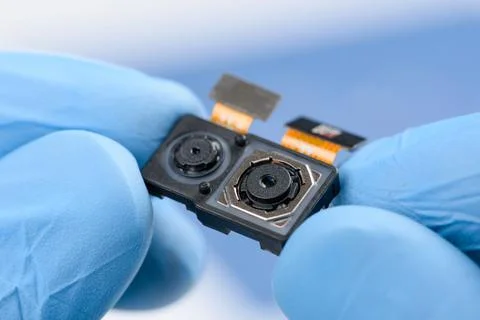 Smartphone dual camera system module in scientist hands Stock Photos