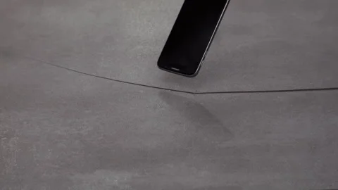 Smartphone falling onto a tile floor in slow motion Stock Footage 300790157