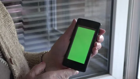 Smartphone with a green background on the screen. Stock Footage 154866540