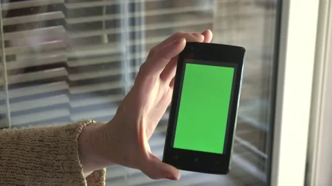 Smartphone with a green background on the screen. Stock Footage 154866558