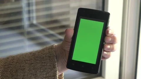 Smartphone with a green background on the screen. Stock Footage 154866582