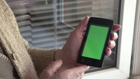 Smartphone with a green background on the screen. Stock Footage 154866846