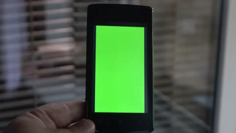Smartphone with a green background on the screen. Stock Footage 154866890