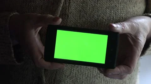 Smartphone with a green background on the screen. Stock Footage 154866906
