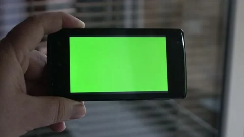 Smartphone with a green background on the screen. Stock Footage 154867326