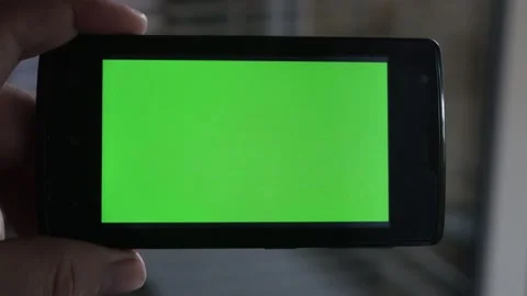 Smartphone with a green background on the screen. Stock Footage 154867348