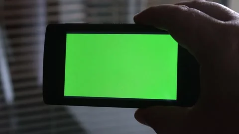 Smartphone with a green background on the screen. Stock Footage 154867368