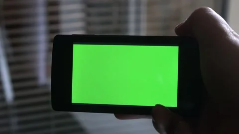 Smartphone with a green background on the screen. Stock Footage 154867530