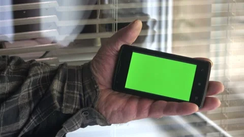 Smartphone with a green background on the screen. Stock Footage 154867669