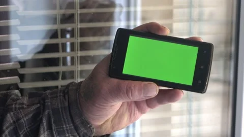 Smartphone with a green background on the screen. Stock Footage 154867688