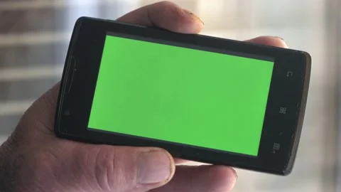 Smartphone with a green background on the screen. Stock Footage 154867871