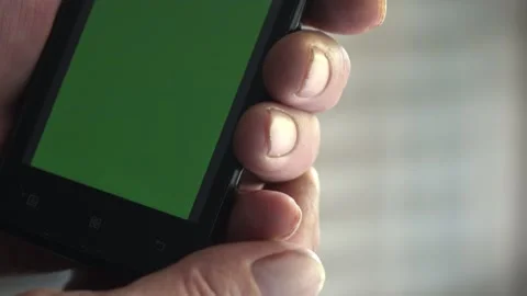 Smartphone with a green background on the screen. Stock Footage 154867874