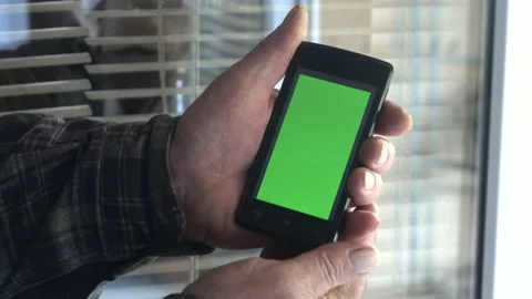 Smartphone with a green background on the screen. Stock Footage 154867948