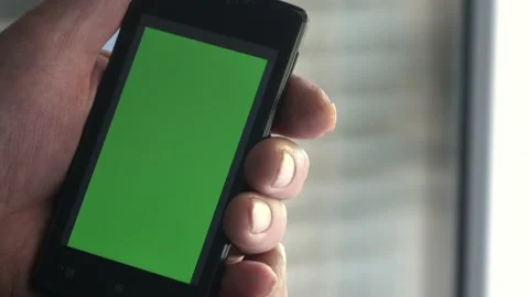 Smartphone with a green background on the screen. Stock Footage 154867958