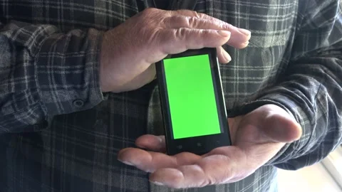 Smartphone with a green background on the screen. Stock Footage 154867988