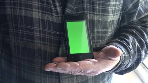 Smartphone with a green background on the screen. Stock Footage 154868146