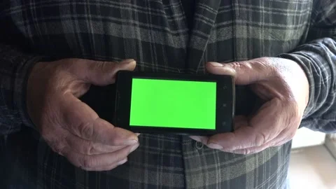 Smartphone with a green background on the screen. Stock Footage 154868167