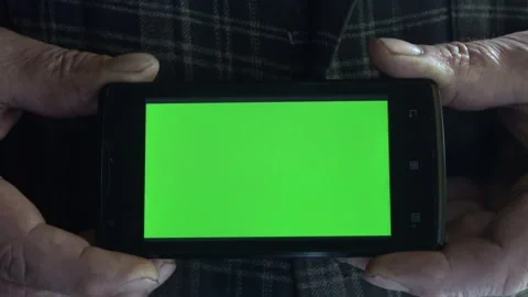 Smartphone with a green background on the screen. Stock Footage 154868204