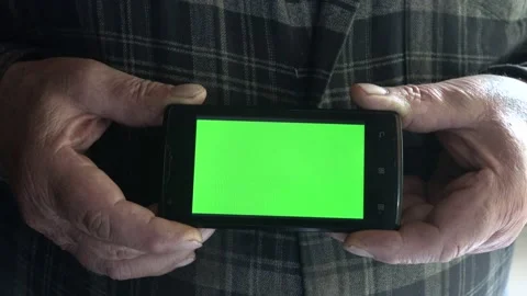 Smartphone with a green background on the screen. Stock Footage 154868211