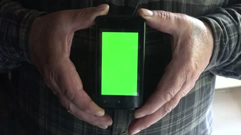 Smartphone with a green background on the screen. Stock Footage 154868218