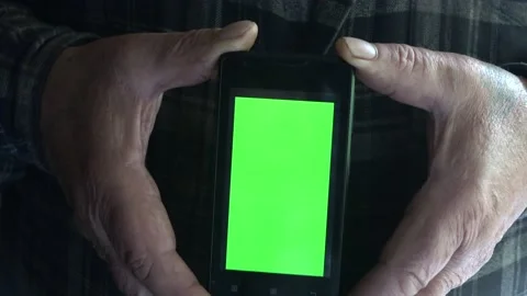 Smartphone with a green background on the screen. Stock Footage 154868228