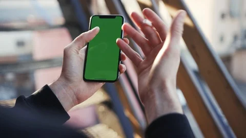 Smartphone with green display in vertical position being used by actively Stock Footage 105261452