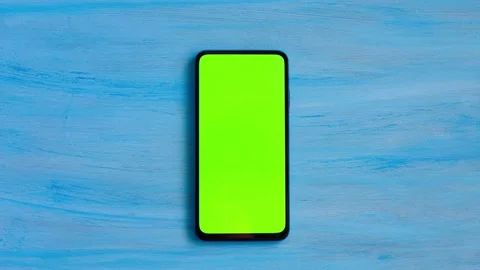 Smartphone with green screen on blue background Stock Footage 230232110