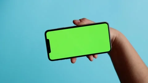 Smartphone with Green Screen on Blue Background Stock Footage 325036281
