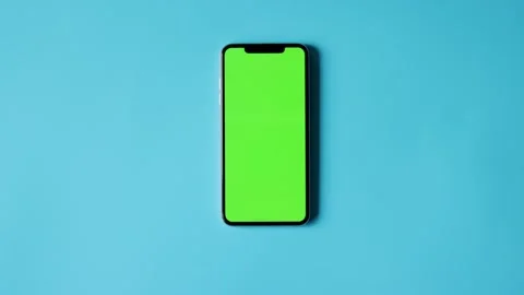 Smartphone with Green Screen on Blue Background Stock Footage 325036289