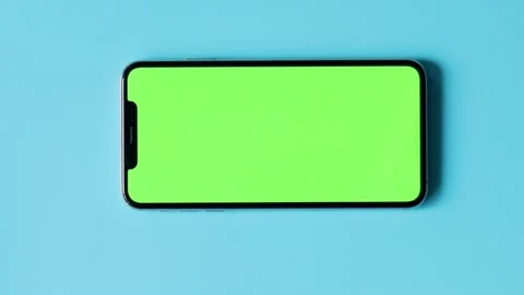 Smartphone with Green Screen on Blue Background Stock Footage 325036291