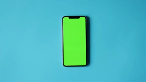 Smartphone with Green Screen on Blue Background 库存影片 325036295