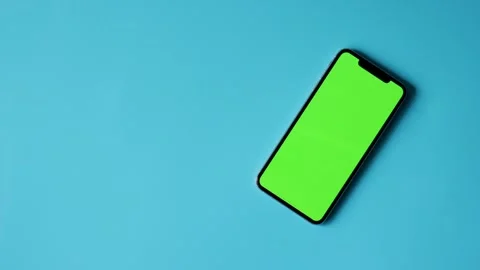 Smartphone with Green Screen on Blue Background Stock Footage 325036300