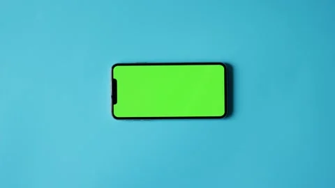 Smartphone with Green Screen on Blue Background Stock Footage 325036301