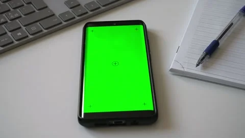 Smartphone with green screen chromakey on white desk. Stock Footage 340890377