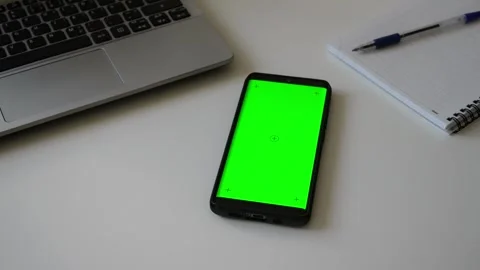 Smartphone with green screen chromakey on white desk. Stock Footage 340890390